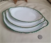 Preowned set of three antique Victoria Austria porcelain oval serving platters with decorative gold and green scalloped edges for elegant dining table centerpieces