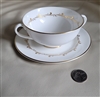Royal Doulton Rondo pattern fine bone porcelain cream soup bowl and saucer set featuring two handles and gold swirl border