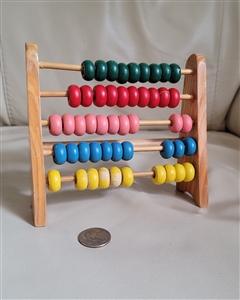 Wooden vintage abacus with colorful sliding beads and wooden frame