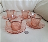 Vintage Arcoroc France four pink glass teacups and saucers set showing a detailed view of the pink swirl pattern on the cups and matching saucers