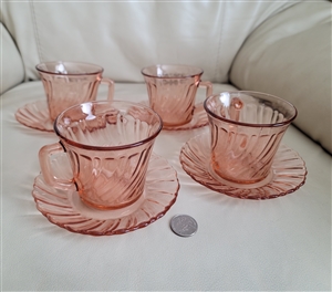 Vintage Arcoroc France four pink glass teacups and saucers set showing a detailed view of the pink swirl pattern on the cups and matching saucers
