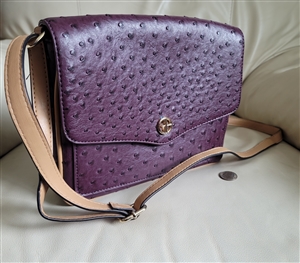 Giani Bernini medium shoulder purse in eggplant purple embossed ostrich faux leather with an adjustable strap and silver logo charm