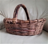 Handwoven willow wicker gathering harvest basket with arched handle showing low center walls and dyed side accent band