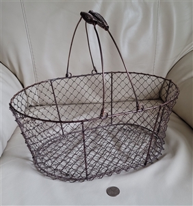 Vintage copper plated farmhouse metal wire gathering basket showing dual coil wrapped handles and mesh body