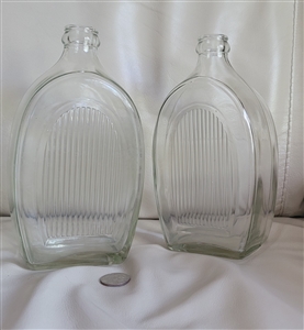 Vintage clear glass bottles with ribbed side and hand blown storage design
