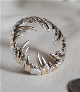 Vintage Sarah Coventry two tone gold and silver swirl brooch front view