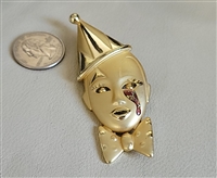 Vintage satin gold tone pierrot face brooch featuring teardrop rhinestone and bow tie accent