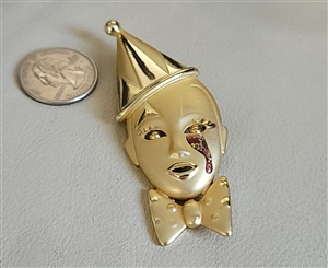 Vintage satin gold tone pierrot face brooch featuring teardrop rhinestone and bow tie accent