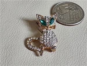 Vintage beaded cat brooch featuring blue cat-eye cabochon eyes and clear beads body