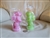 Set of 2 vintage Luminescence bunny rabbit wax candles pink and green with baskets on back