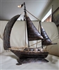 Vintage handcrafted welded metal sailboat sculpture with open spinnaker sail and rustic patina