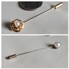 Set of two vintage faux pearl hat pins in gold and silver tone metal shown with coin for scale