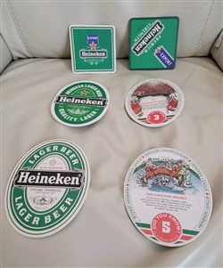 A set of six reversible Heineken beer mats showing both the logo side and the hockey trivia reverse side