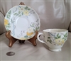 Preowned vintage Tuscan porcelain teacup and saucer set featuring hand painted yellow blossoms with raised enamel jeweling dots and gold trim