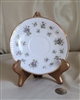 Preowned vintage Royal Minster England porcelain saucer featuring a purple floral bouquet design and gold-tone rim