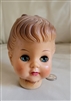 Vintage rubber doll head, close and open eyes.