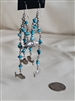 Vintage cascading dangle earrings featuring silver tone metal, turquoise stones, and whimsical fish charms