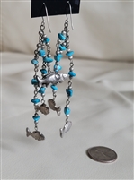 Vintage cascading dangle earrings featuring silver tone metal, turquoise stones, and whimsical fish charms