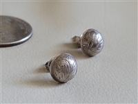 Round sterling silver concho stud earrings with engraved feather nature design next to a coin for scale Round sterling silver concho stud earrings with engraved feather nature design next to a coin for scale