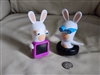 Two white interactive rabbit toys from 2015 McDonalds Happy Meal including spinner and xray light up versions