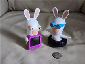 Two white interactive rabbit toys from 2015 McDonalds Happy Meal including spinner and xray light up versions