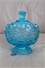 Vivid blue vintage L.E. Smith Moon and Stars lidded pedestal candy dish with embossed pattern, Side view of lidded blue glass candy dish on pedestal base showing vintage wear and patina, Close up of the faceted glass lid finial and moon and star pattern o