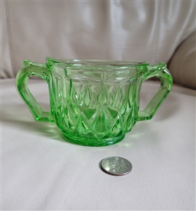 Vintage green depression glass sugar bowl with two handles and star pattern base