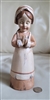 Praying pilgrim resin girl statue 8-3/4" tall in Woodlake grain finish.
