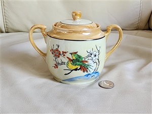 Japanese lustreware porcelain lidded sugar bowl featuring hand-painted birds on branches peach and yellow lustre glaze twin handles and matching lid from the 1930s