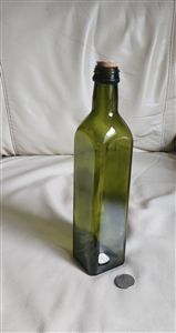 Vintage hunter green glass storage bottle with paneled sides and cork stopper