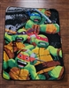 TMNT 2014 Nickelodeon multi-color fleece throw blanket featuring a vibrant all-turtles design preowned