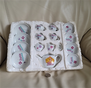 Vintage miniature porcelain tea set with 16 pieces, Barbie graphics, and original styrofoam insert tray