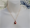 Guilloche style vintage red enamel egg pendant with faux pearls on gold tone chain