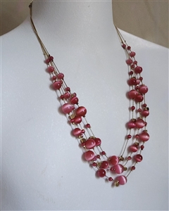 preowned vintage pink cat eye multi strand waterfall necklace with gold tone charms