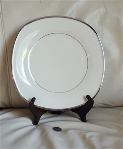 Vintage 1965 Lenox Solitaire ivory porcelain square dinner plate with a polished platinum trim on a warm ivory body