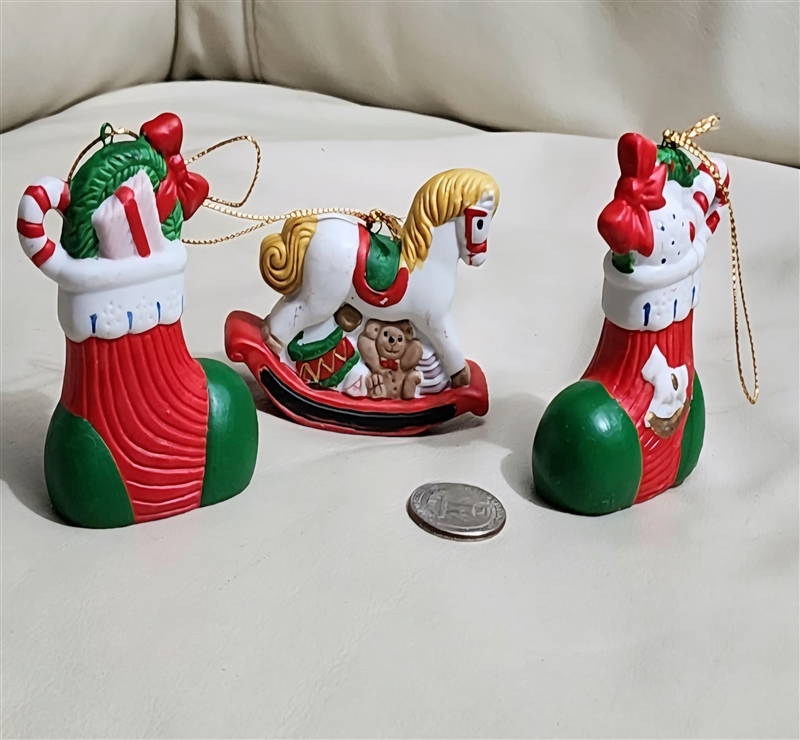 Set of 3 vintage hand-painted ceramic Christmas ornaments including a rocking horse and two stockings shown with reference coin