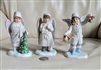 ENESCO 1986 angel figurine set with Christmas carolers, including boys with bells and tree, and girl in winter dress