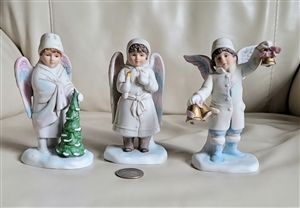 ENESCO 1986 angel figurine set with Christmas carolers, including boys with bells and tree, and girl in winter dress