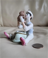 Hallmark 1987 vintage porcelain Christmas ornament featuring a seated mime holding up a teddy bear with pink shoes