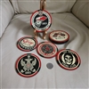 Four circular Shepard Fairey OBEY GIANT coasters with various street art designs displayed alongside their red and black metal storage tin