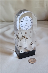 1970s clear lucite watch part explosion paperweight with embedded invicta watch face preowned