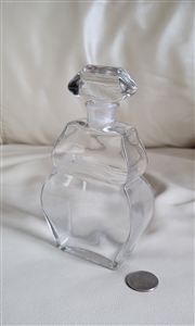Mid-century vintage French clear glass perfume bottle featuring geometric flowing pattern and matching apothecary stopper