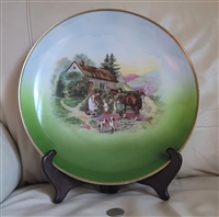 Large vintage German porcelain twelve inch decorative plate with colorful cottage and family scene