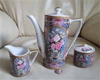 Andrea by Sadek three piece Japanese porcelain tea set featuring a lidded teapot creamer and lidded sugar bowl with pink roses griffins and gold trim from the 1980s