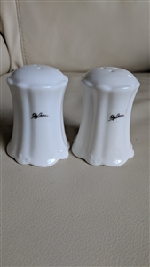 set of two white ribbed porcelain salt and pepper shakers with oleg cassini branding