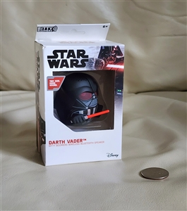 New old stock box displaying a black 2019 Star Wars Darth Vader helmet mini bluetooth speaker next to a coin for size reference