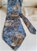 Pre-owned vintage Endangered Species 100% silk tie with detailed African wildlife illustrations including lions and elephants on a blue background.