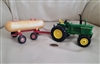 Vintage ERTL John Deere 4020 Diesel tractor and 17280 red metal water wagon tanker with visible vintage wear