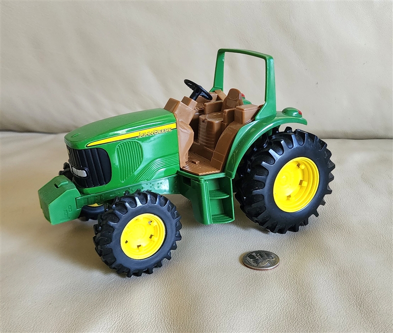 Vintage ERTL John Deere steerable tractor toy with metal frame and plastic undercarriage