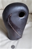 Preowned 1980s studio art pottery large black closed form seed pod vase with pressed feather design and hand carved side monogram next to a quarter for size scale